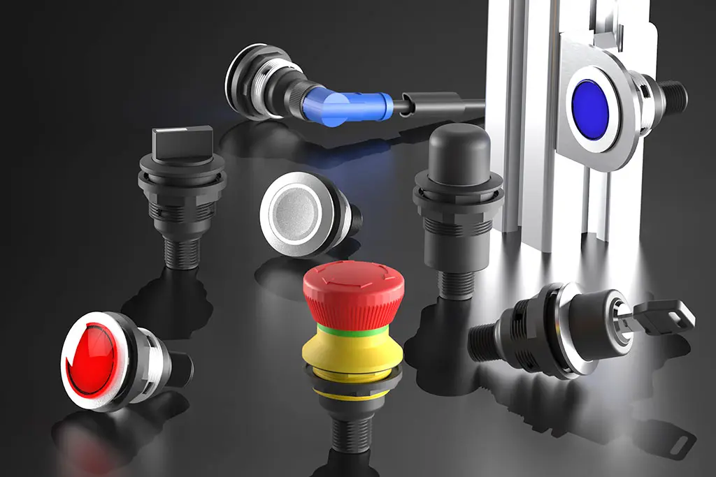 Not-Halt-Taster, Drucktasten, Schlüsselschalter und Wahlschalter mit M12-Anschluß auf einer schwarz-spiegelnden Oberfläche. Manche Taster liegen, andere stehen.