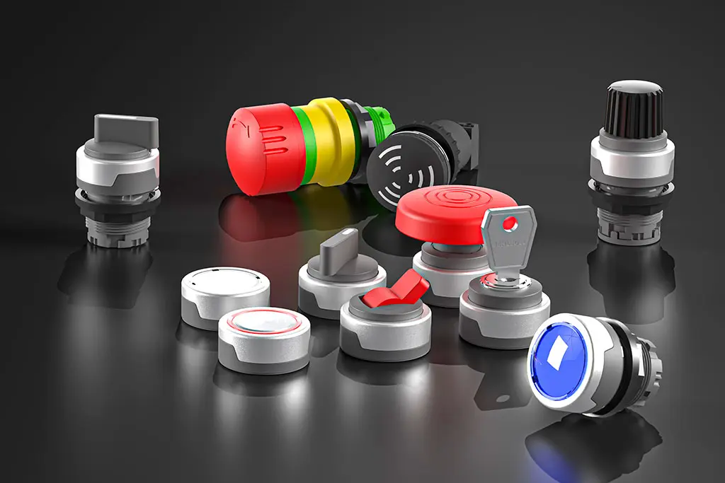 Not-Halt-Taster, Drucktasten, Schlüsselschalter und Wahlschalter auf einer schwarz-spiegelnden Oberfläche. Manche Taster liegen, andere stehen.