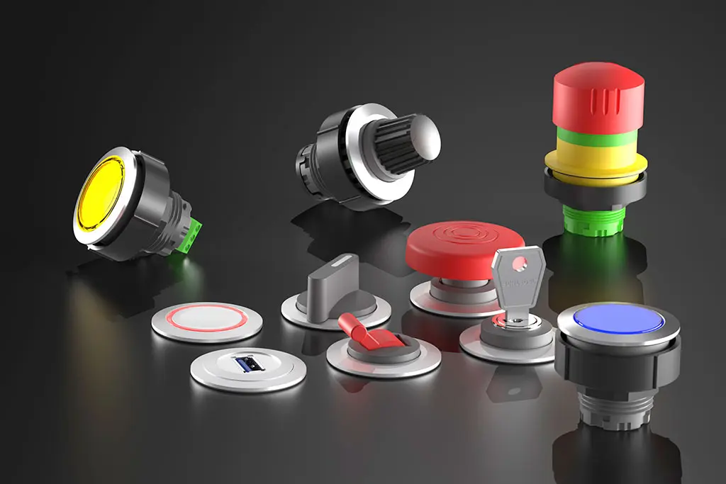 Not-Halt-Taster, Drucktasten, Schlüsselschalter und Wahlschalter auf einer schwarz-spiegelnden Oberfläche. Manche Taster liegen, andere stehen.